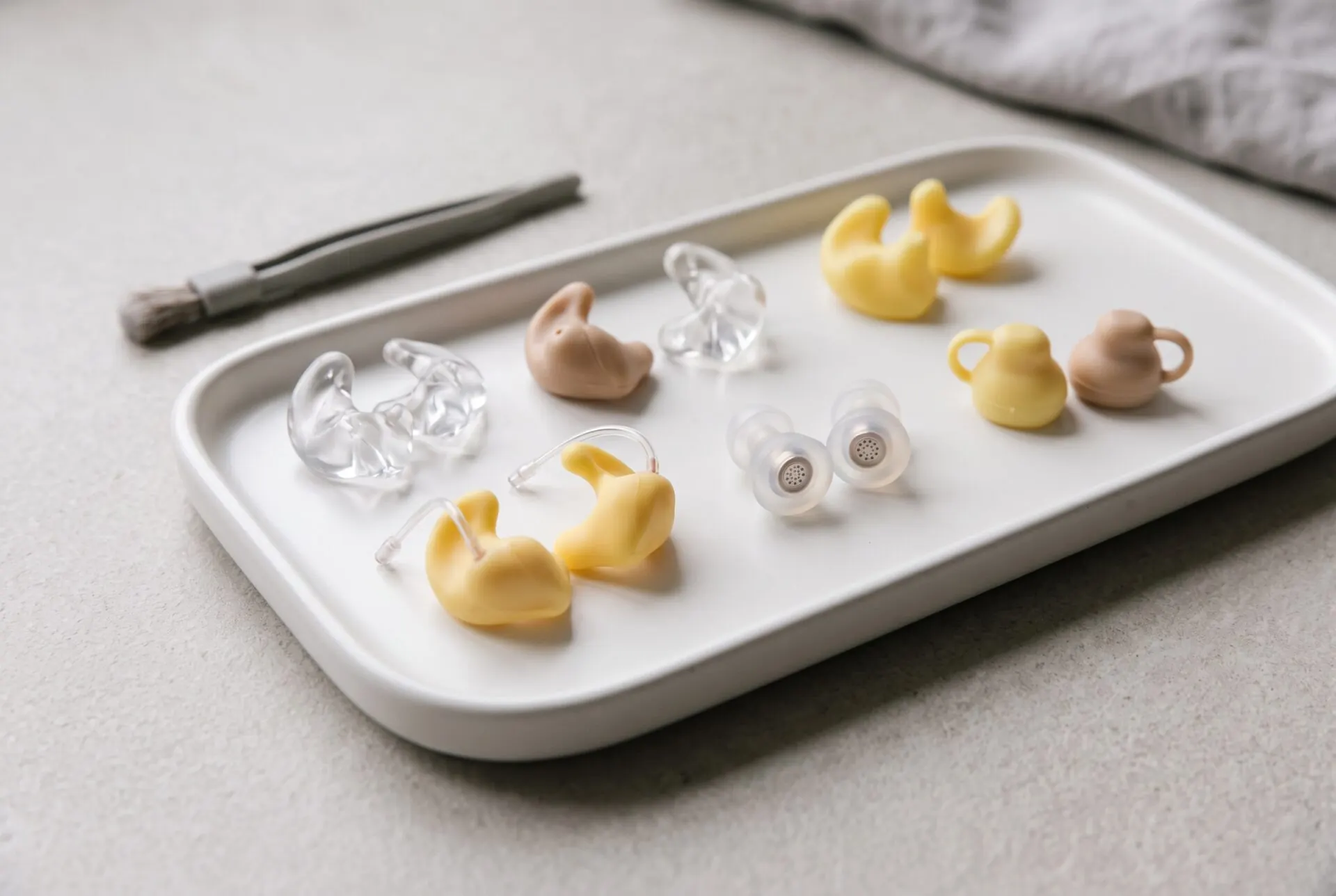Custom ear molds and earplugs on a tray